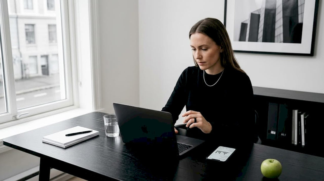 Woman checking smart ring data at kitchen table